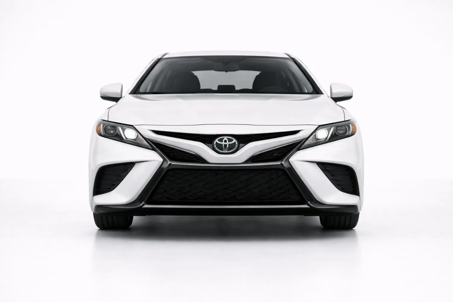 Toyota Camry front view showing bold grille, sharp LED headlights, and executive sedan stance